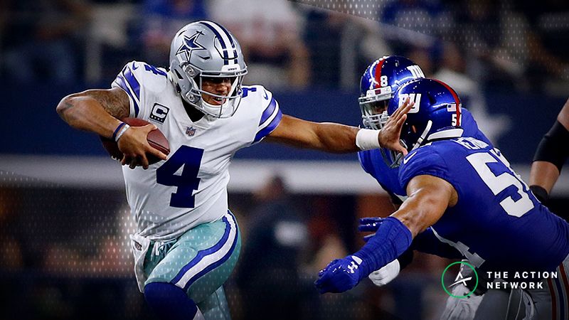 Dallas Cowboys quarterback Dak Prescott (4) breaks a tackled by New York Giants defensive end Romeo Okwara (78) and defensive end Olivier Vernon (54) in the second quarter at AT&T Stadium.