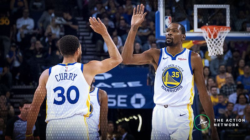 Golden State Warriors forward Kevin Durant (35) and guard Stephen Curry (30) celebrate against the Phoenix Suns during the first quarter at Oracle Arena.